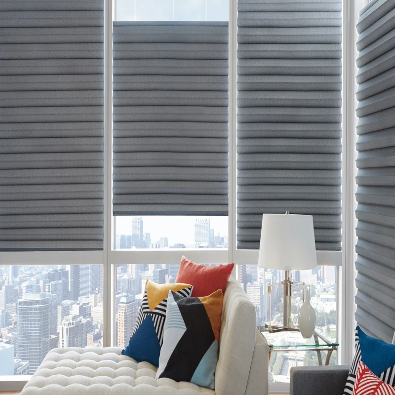 Motorized gray pleated shades at different heights