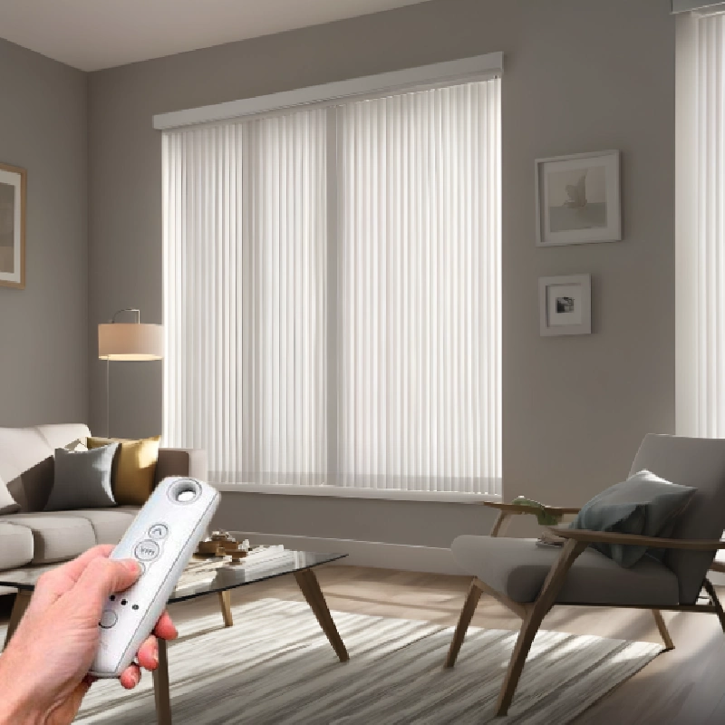 remote control held in a living room to operate white motorized vertical blinds