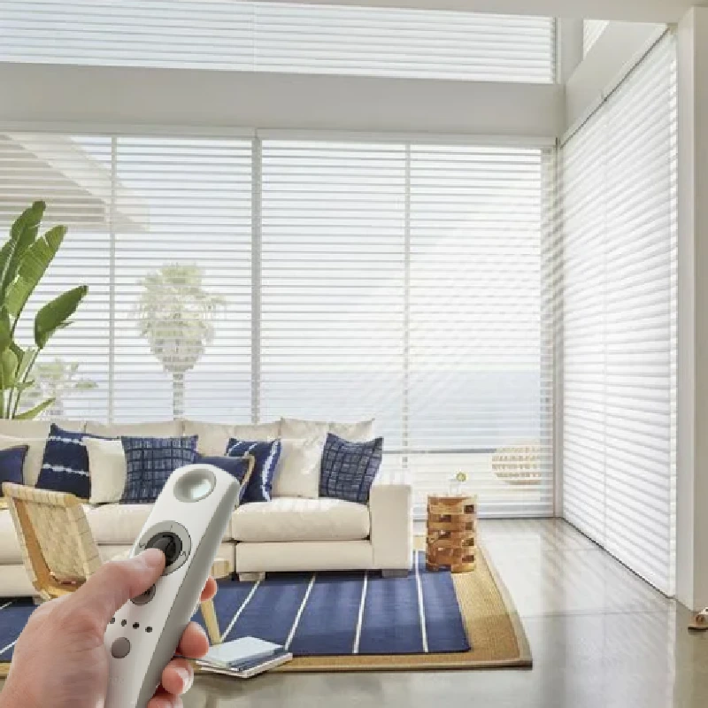 remote control held in front of white motorized sheer horizontal blinds